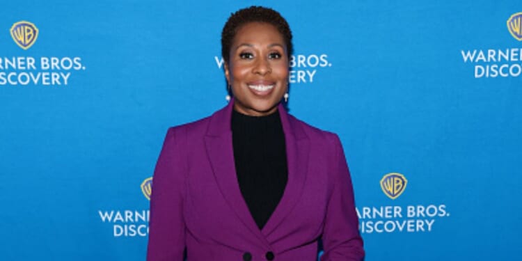 “CNN This Morning” host Audie Cornish stands at a red carpet in a purple pantsuit on May 15, 2025.