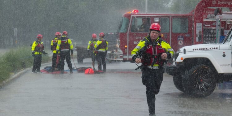 Texas flooding surges from huge rainstorms as rescuers pull people from rising waters