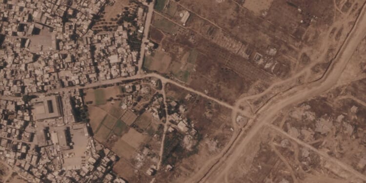 Israel is building a miles-long earthen barrier inside Gaza, entrenching its division