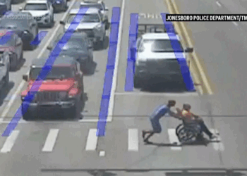 Spider-Man moonlights as good Samaritan, guides man in wheelchair across long crosswalk in Arkansas