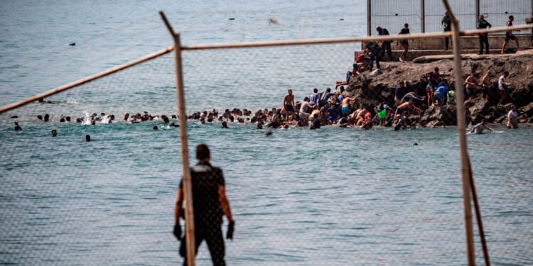 Military called out after thousands breach Moroccan border to enter Spanish city
