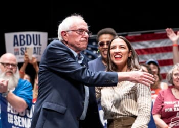 Sen. Bernie Sanders, an Independent from Vermont, greets Rep. Alexandria Ocasio-Cortez, a Democrat from New York, at The People v. The Powerful rally at the Detroit Opera House on July 18, 2026, in Detroit, Michigan.