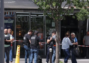 Judicial police work in a cordoned off area after a knife-wielding man wounded three people in Paris on July 27, 2026.
