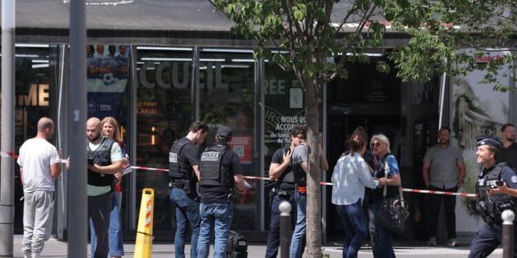 Judicial police work in a cordoned off area after a knife-wielding man wounded three people in Paris on July 27, 2026.