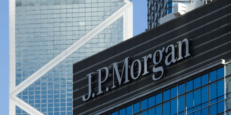The JPMorgan sign is displayed on an office building with the Bank of China Tower in the background on June 21, 2026, in Hong Kong, China.