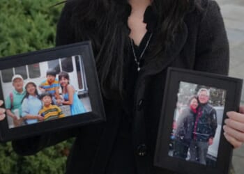 Grace Jin Drexel stands with photos of her father, Ezra Jin, on October 30, 2025 in Washington, D.C. during an interview.