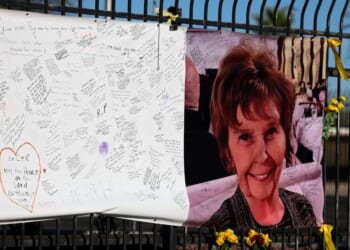 A photograph of Nancy Guthrie is seen on a sign that people can leave messages on Feb. 26, 2026, in Tucson, Arizona.