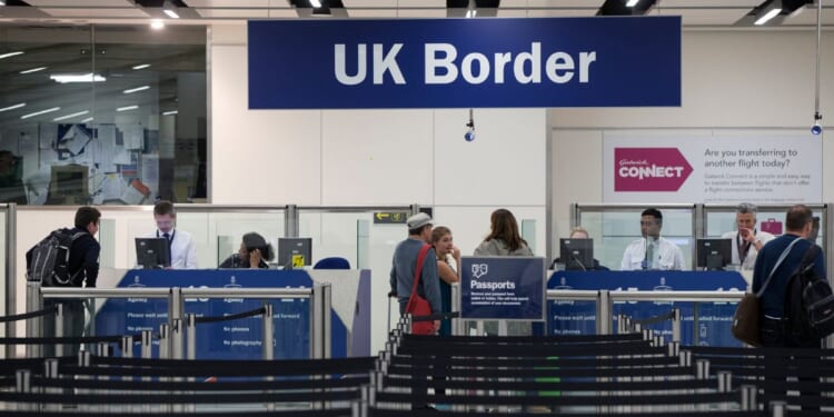A line in front of the UK Border Force checkpoint at Gatwick Airport on May 28, 2014 in London.