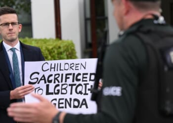 Members of the family of Enoch Burke, a teacher at the center of a case regarding pronoun usage, protest outside the La Mon hotel in Comber, Northern Ireland on Sept. 20, 2025.