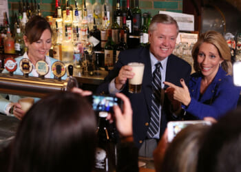 Dana Bash, Senator Lindsey Graham, and his sister Darline Graham Nordone serve guests prior to CNN's Politics On Tap at Walnut Brewery on October 27, 2015 in Boulder, Colorado.