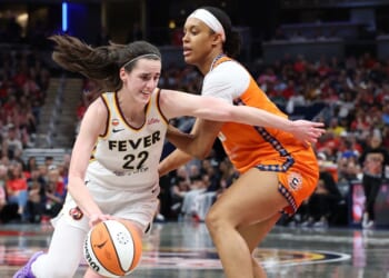 Caitlin Clark of the Indiana Fever dribbles the ball while defended by Nell Angloma of the Connecticut Sun at Gainbridge Fieldhouse on July 22, 2026, in Indianapolis, Indiana.