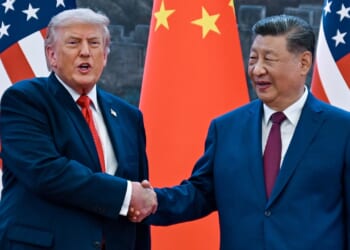 Donald Trump (R) shakes hands with China's President Xi Jinping