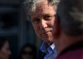 Sherrod Brown, an Ohio Democrat, looks on at another person.