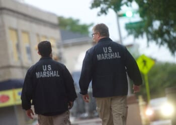 U.S. Marshals monitor activity outside the Martin Luther King, Jr. Federal Courthouse before opening statements are heard in the "Bridgegate" trial on Sept. 19, 2016, in Newark, New Jersey.