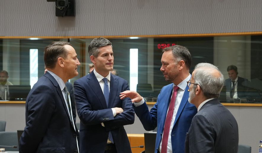 From left, Poland's Foreign Minister Radoslaw Sikorski, Netherland's Foreign Minister Tom Berendsen, Belgium's Foreign Minister Maxime Prevot and Portugal's Foreign Minister Paulo Rangel during a round table meeting of EU foreign ministers in Brussels, Monday, July 13, 2026. (AP Photo/Marius Burgelman)