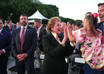 Secretary of Education Linda McMahon plays with a child of U.S. Secretary of Transportation Sean Duffy.