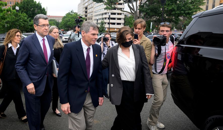 Former Olympic canoeist David Hearn, center, and his attorney Norman Eisen, left, walk to a car following a court appearance, where he pleaded not guilty to allegedly damaging the Lincoln Memorial Reflecting Pool, Thursday, July 9, 2026, in Washington. (AP Photo/Rod Lamkey, Jr.)
