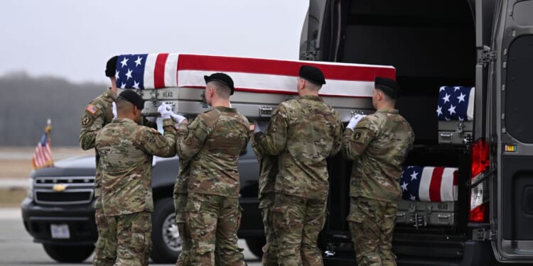A U.S. Army carry team transports a flag-draped transfer case to a vehicle during a dignified transfer at Dover Air Force Base on March 7, 2026, in Dover, Delaware.