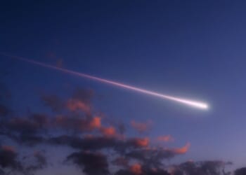 A bright shooting star above the clouds.