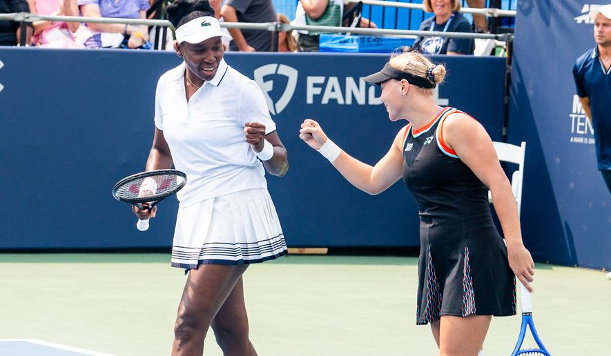 Venus Williams of the United States (left) and Diana Shnaider of Russia celebrate a point during a first round doubles match at the DC Open tennis tournament in Washington, D.C., Monday, July 27, 2026. (All-Pro Reels)