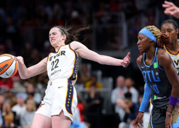 Caitlin Clark loses her balance after being fouled.