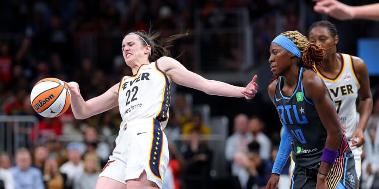 Caitlin Clark loses her balance after being fouled.