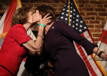 Democratic Florida gubernatorial candidate Gwen Graham (R) is kissed by her mother Adele Graham after conceding the primary to Andrew Gillum on August 28, 2018.