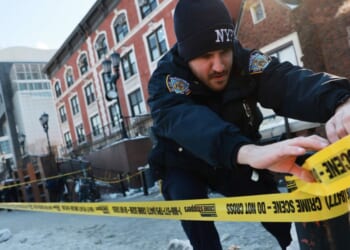 Police put up crime scene tape as members of the Hasidic Jewish community gather outside of the Chabad Lubavitch world headquarters, where a man was arrested Wednesday evening after repeatedly crashing his car into a door of the building on Jan. 29, 2026, in New York City.
