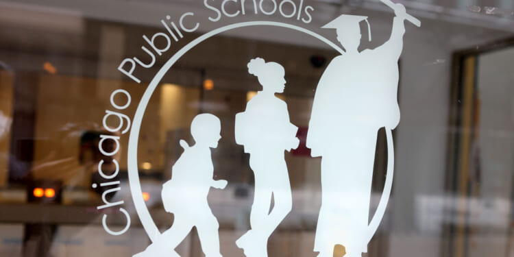 A sign is displayed on the front of the headquarters for Chicago Public Schools.