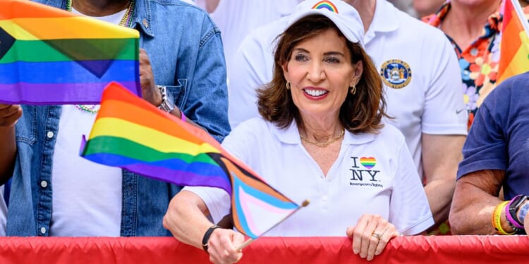 New York Gov. Kathy Hochul waves a transgender flag during the 2026 "Pride March" on June 28 in New York City.