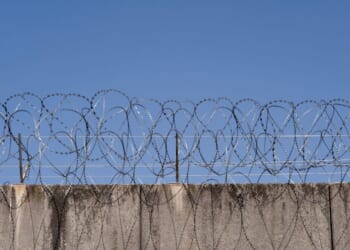 A prison wall with barbed wire in Frankfurt, Germany.