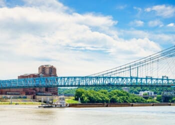 Barges are going under the Roebling Bridge in Cincinnati, Ohio.
