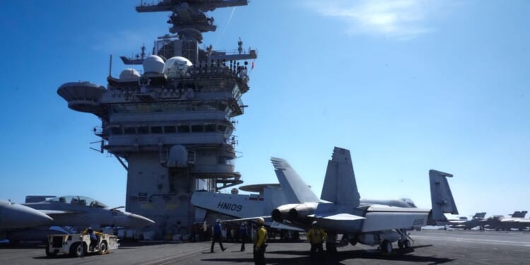 U.S. Navy aircraft sit on the flight deck of the USS Theodore Roosevelt aircraft carrier in Honolulu, Hawaii, on July 17, 2026.