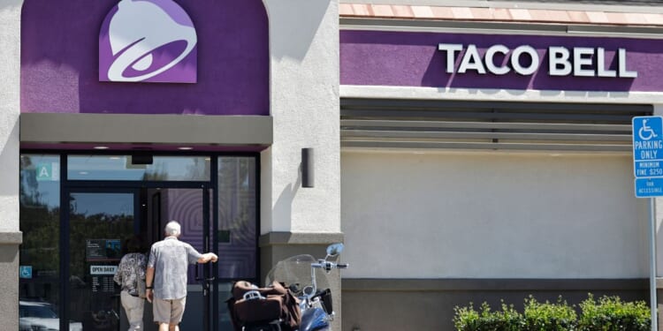 Customers enter a Taco Bell restaurant on July 14, 2026, in La Cañada Flintridge, California.