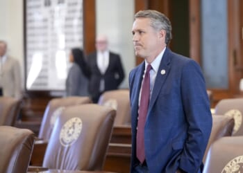 Texas state Rep. Brian Harrison arrives in the House Chamber at the Capitol in Austin.