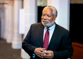 Lonnie Bunch III stands in the "American Aspirations" exhibit at the Smithsonian Castle on the National Mall.