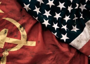 Muddied USSR and American flags lay next to each other.