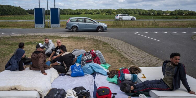 Asylum seekers camp out close to an application center in Ter Apel in the Netherlands on Aug. 28, 2022.
