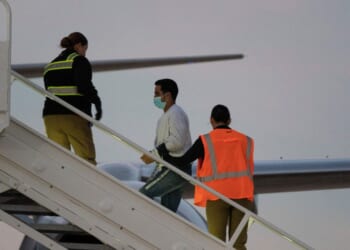 A man in shackles boards the first deportation flight of undocumented Venezuelans after a U.S.-Venezuelan agreement in Harlingen, Texas, on Oct. 18, 2023.