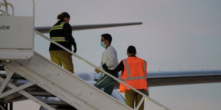 A man in shackles boards the first deportation flight of undocumented Venezuelans after a U.S.-Venezuelan agreement in Harlingen, Texas, on Oct. 18, 2023.
