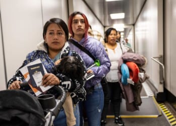 Andrea, and her cousin Jennyfer, nervously prepare to board their flight to Ecuador from JFK International Airport on Oct. 27, 2025, in New York, New York.