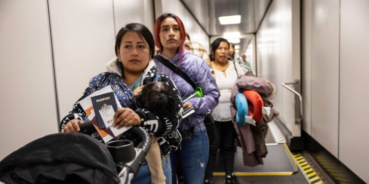 Andrea, and her cousin Jennyfer, nervously prepare to board their flight to Ecuador from JFK International Airport on Oct. 27, 2025, in New York, New York.