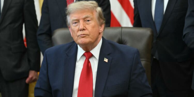 President Donald Trump looks on after signing an executive order to drastically shrink two national monuments in Utah, paving the way for fossil fuel extraction and mining, at the Oval Office of the White House in Washington, D.C., on July 13, 2026.