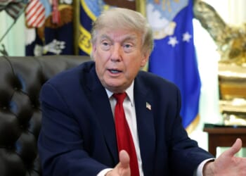 President Donald Trump sits at the desk in the Oval Office of the White House as he speaks to reporters on June 29, 2026 in Washington.