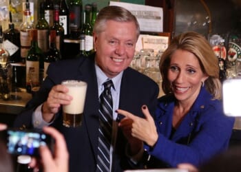 GOP Sen. Lindsey Graham of South Carolina and his sister, Darline Graham Nordone, serve guests prior to CNN's "Politics On Tap" at Walnut Brewery on Oct. 27, 2015, in Boulder, Colorado.