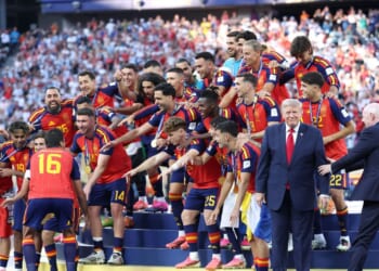 Rodri of Spain prepares to lift the FIFA World Cup Winner’s Trophy as FIFA President Gianni Infantino directs President Donald Trump after the team’s victory following during the FIFA World Cup 2026 Final match between Spain and Argentina at New York New Jersey Stadium on July 19, 2026, in East Rutherford, New Jersey.