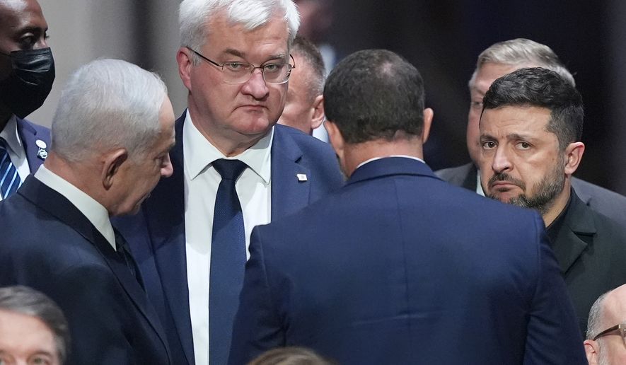 Israeli Prime Minister Benjamin Netanyahu, left, speaks to President of Ukraine, Volodymyr Zelenskyy, right, before the funeral of Sen. Lindsey Graham, R-S.C., Tuesday July 28, 2026, at the Washington National Cathedral in Washington. (AP Photo/Jacquelyn Martin)