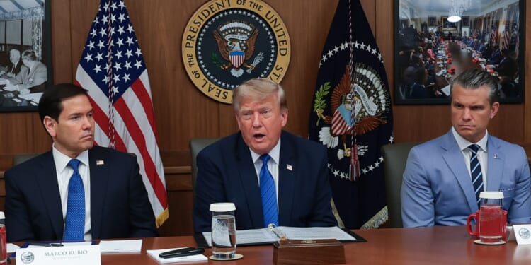 President Donald Trump speaks during a Cabinet meeting Friday at Camp David, the presidential retreat, flanked by Secretary of State Marco Rubio, left, and Secretary of Defense Pete Hegseth, right.