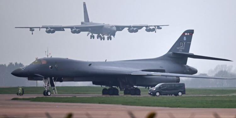 A U.S. Air Force Boeing B-52 Stratofortress bomber jet lands on the runway, beyond a USAF Rockwell B-1 Lancer bomber jet, at RAF Fairford in southwest England on March 9, 2026.