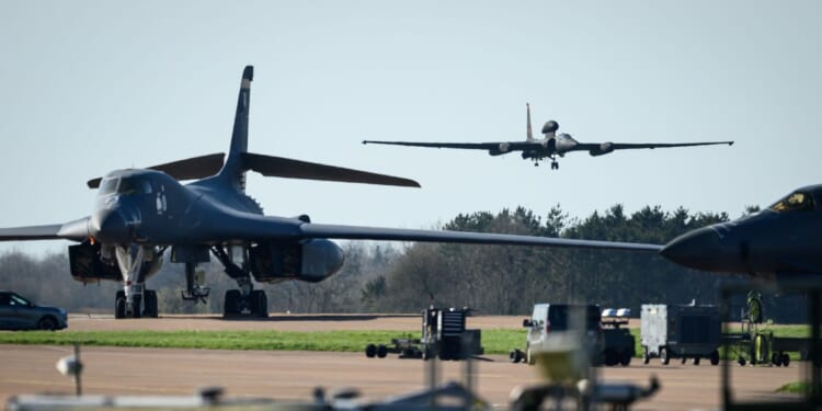 A Lockheed U-2 "Dragon Lady" high–altitude reconnaissance aircraft comes into land beyond two parked Rockwell B-1 Lancer heavy bombers at RAF Fairford on March 18, 2026, in Fairford, England.